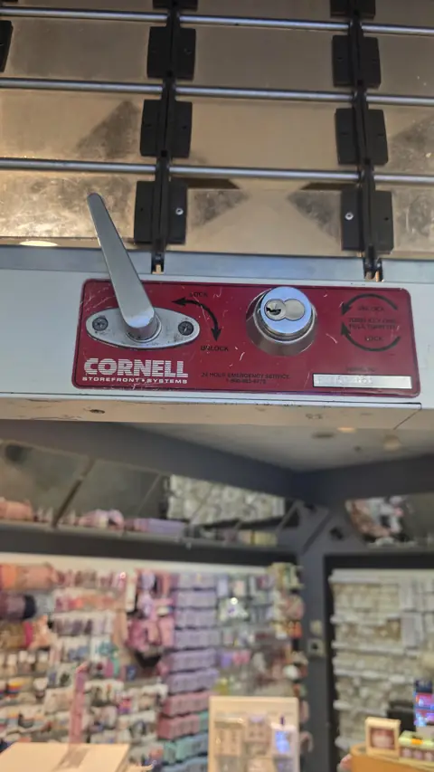 Cornell rolling security grille lock serviced at a retail store