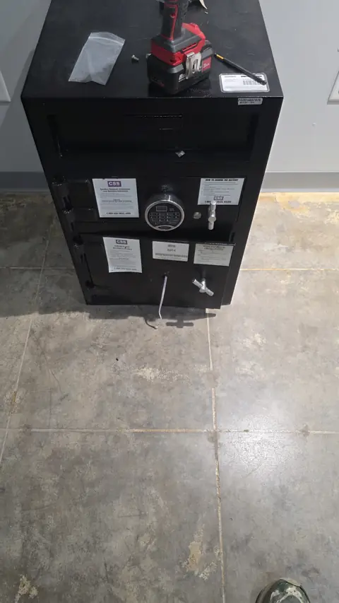 Commercial drop safe with an electronic lock being installed