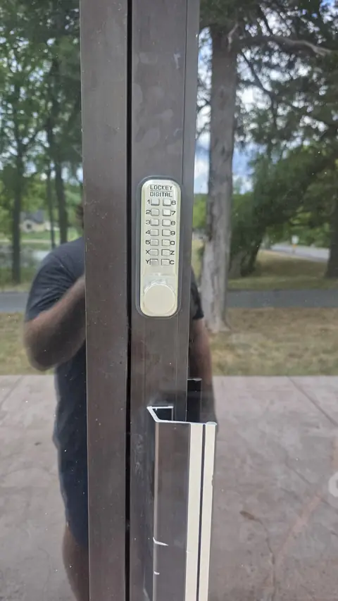 Mechanical push-button keypad lock installed on a gate