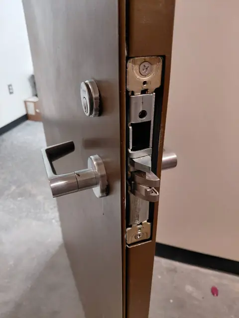 Commercial mortise lever lock installed on an office door