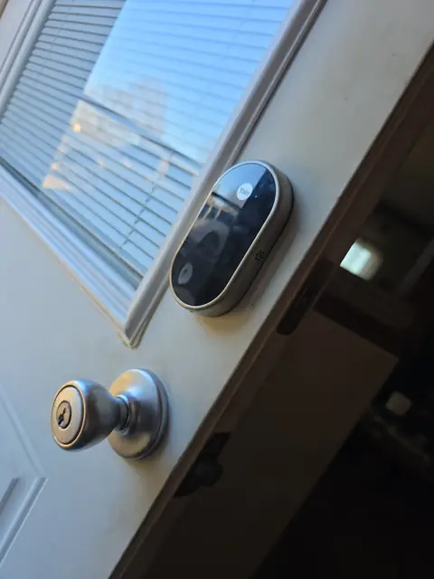 Smart deadbolt and keyed knob installed on a front entry door