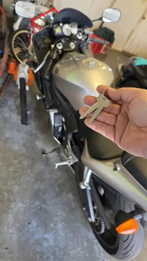 Two replacement keys made for a silver sport motorcycle